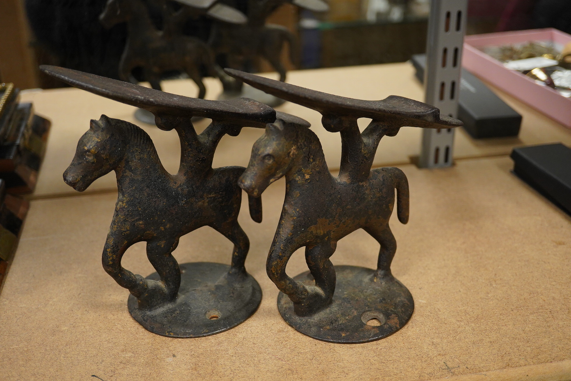 A small pair of novelty iron ‘horse’ boot scrapers. 18cm high. Condition - poor, base mounts missing